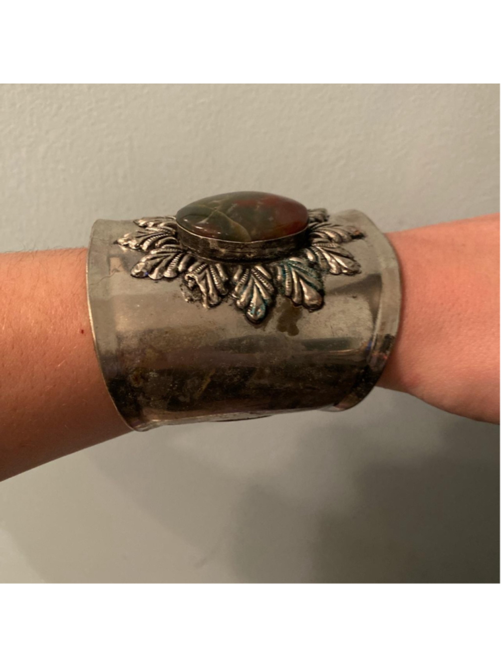 Vintage silver cuff with stone in the middle and pattern on the outside of the s